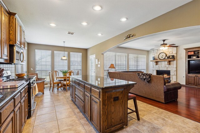 kitchen with plenty of natural light, a breakfast bar area, stainless steel appliances, and visible vents