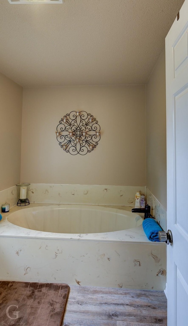 221 Summit Dr, Bossier City, LA 71111 - bathroom with a textured ceiling and a bath