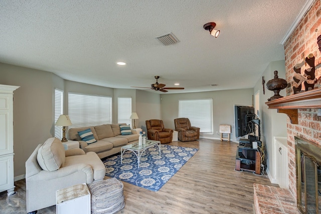 221 Summit Dr, Bossier City, LA 71111 - living area with wood finished floors, baseboards, visible vents, ceiling fan, and a brick fireplace