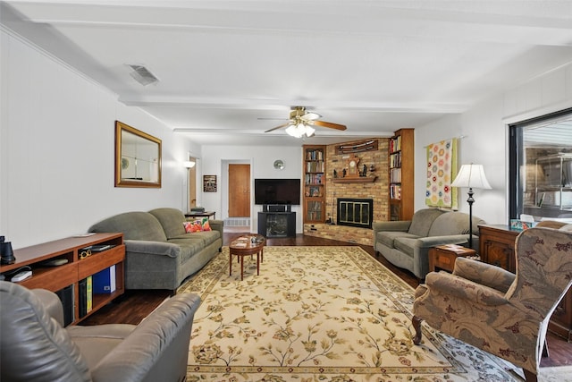 3433 Lawndale Ave, Fort Worth, TX 76133 - living area with visible vents, beamed ceiling, wood finished floors, a brick fireplace, and ceiling fan