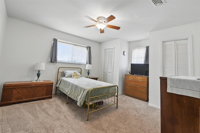 3433 Lawndale Ave, Fort Worth, TX 76133 - bedroom with baseboards, visible vents, carpet floors, ceiling fan, and two closets