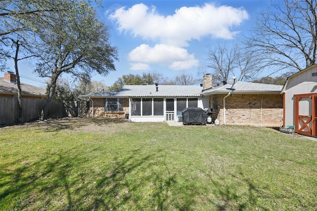 3433 Lawndale Ave, Fort Worth, TX 76133 - back of property featuring an outbuilding, a fenced backyard, a sunroom, a chimney, and a lawn