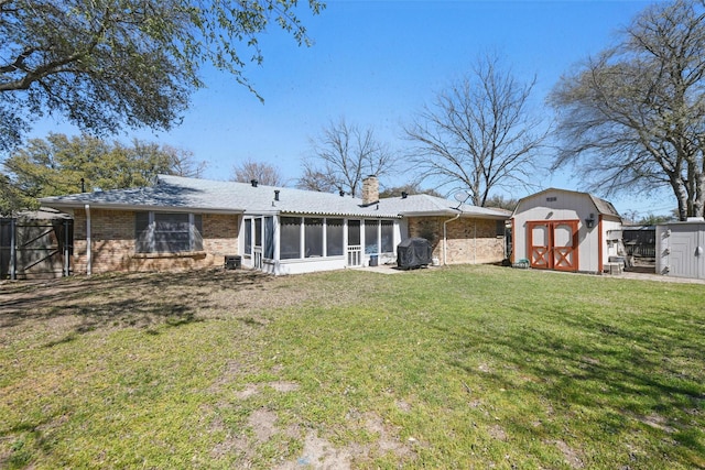3433 Lawndale Ave, Fort Worth, TX 76133 - back of property featuring a lawn, a shed, an outdoor structure, a sunroom, and a chimney