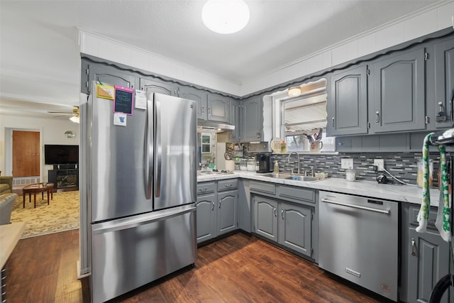 3433 Lawndale Ave, Fort Worth, TX 76133 - kitchen with dark wood-style floors, gray cabinetry, a sink, light countertops, and appliances with stainless steel finishes