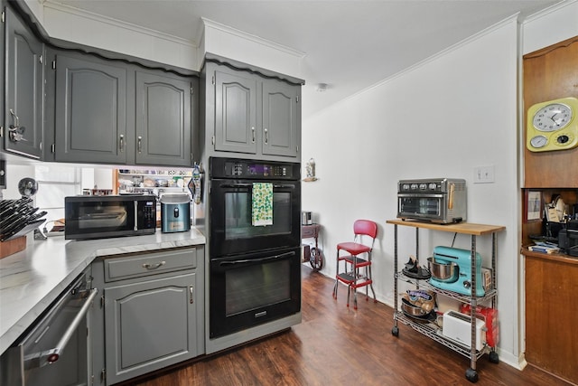 3433 Lawndale Ave, Fort Worth, TX 76133 - kitchen with black appliances, gray cabinets, dark wood-style floors, crown molding, and light countertops