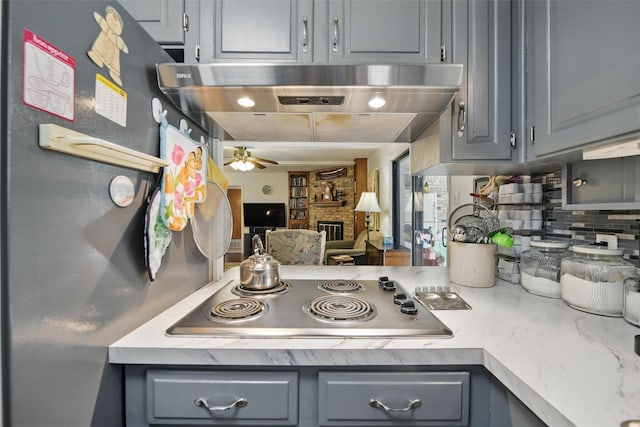 3433 Lawndale Ave, Fort Worth, TX 76133 - kitchen with appliances with stainless steel finishes, gray cabinetry, and wall chimney range hood