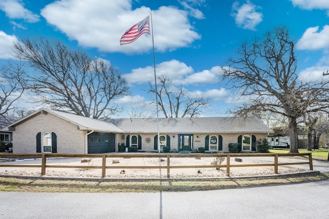 18341 Shore Dr, Kemp, TX 75143 - view of front of home featuring brick siding, a fenced front yard, and a garage