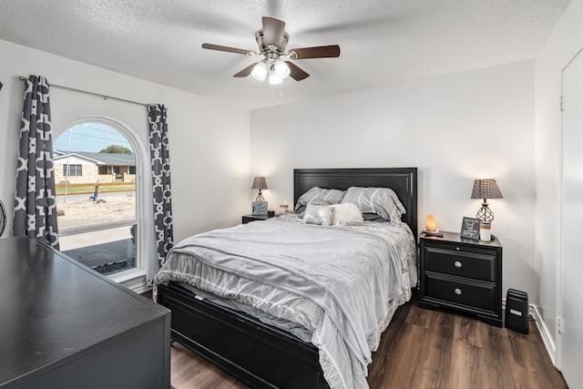 18341 Shore Dr, Kemp, TX 75143 - bedroom with baseboards, a textured ceiling, ceiling fan, and dark wood-style floors