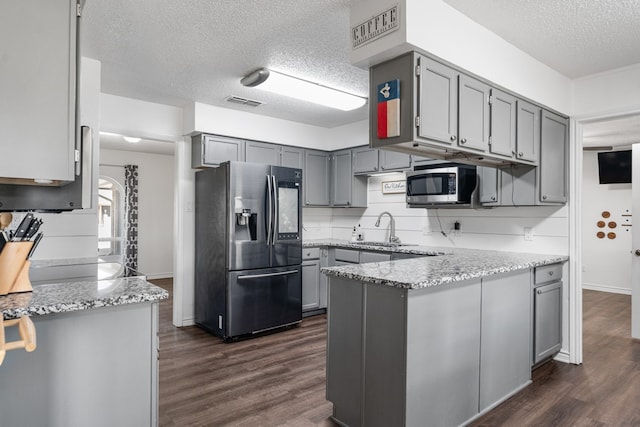 18341 Shore Dr, Kemp, TX 75143 - kitchen with a textured ceiling, gray cabinetry, and stainless steel appliances