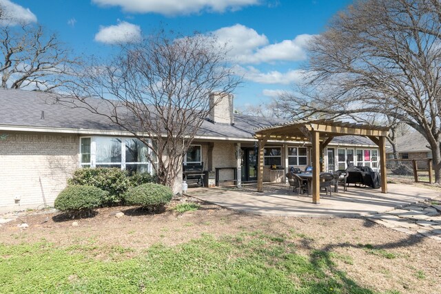 18341 Shore Dr, Kemp, TX 75143 - rear view of property featuring fence, a pergola, a patio, a chimney, and brick siding