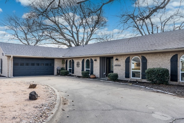 18341 Shore Dr, Kemp, TX 75143 - single story home with a shingled roof, an attached garage, concrete driveway, and brick siding