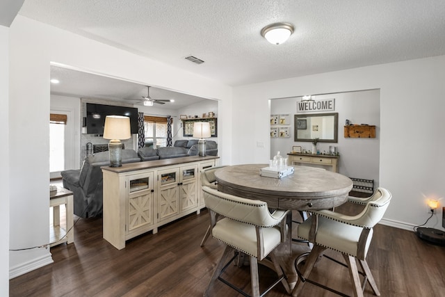 18341 Shore Dr, Kemp, TX 75143 - dining room featuring ceiling fan, dark wood-type flooring, a textured ceiling, and visible vents