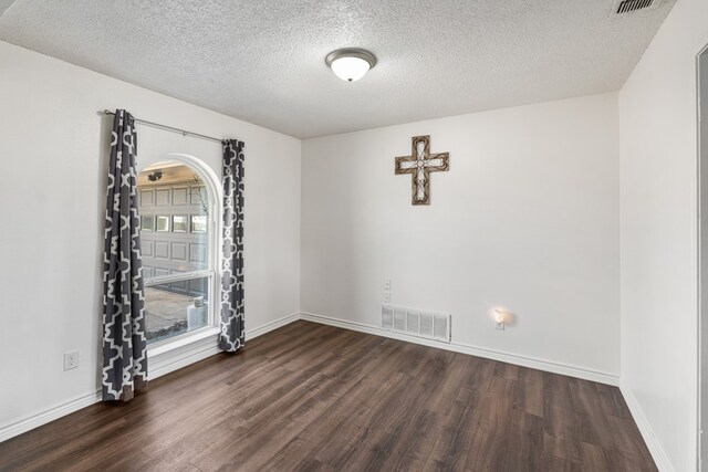 18341 Shore Dr, Kemp, TX 75143 - empty room with a textured ceiling, wood finished floors, and visible vents