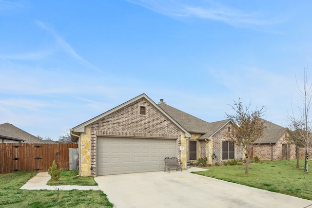 949 Avagail, Springtown, TX 76082 - view of front facade featuring a gate, fence, concrete driveway, an attached garage, and a front yard