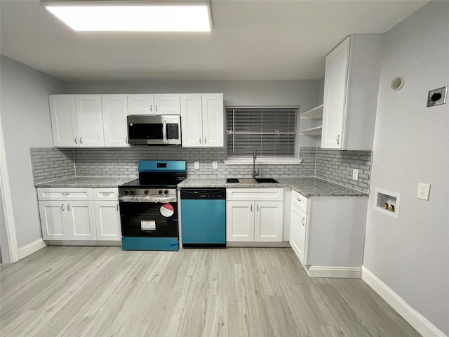 1305 S 1st St, Corsicana, TX 75110 - kitchen featuring backsplash, a sink, baseboards, white cabinets, and stainless steel appliances
