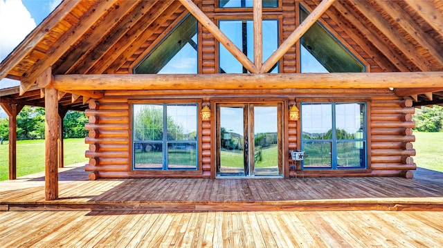 exterior space with high vaulted ceiling, wood-type flooring, log walls, and beam ceiling