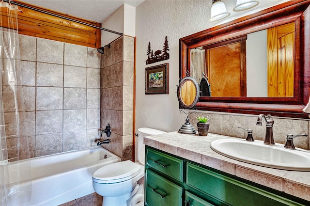 full bath with toilet, a textured wall, shower / tub combination, and vanity