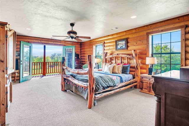 bedroom featuring carpet flooring, access to outside, recessed lighting, a ceiling fan, and rustic walls