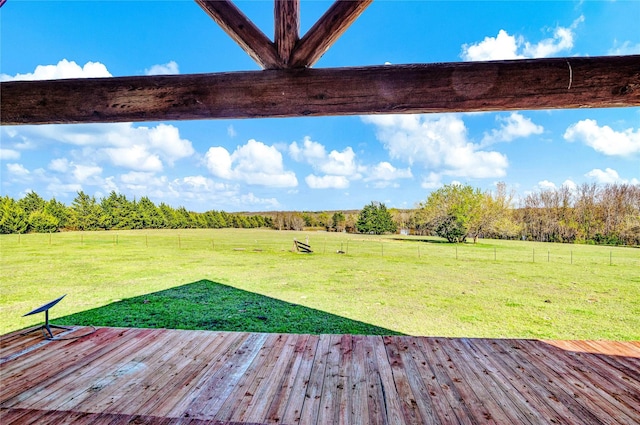wooden deck with a yard and a rural view