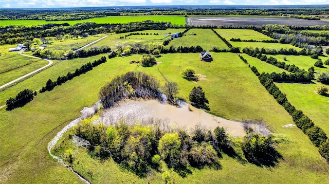birds eye view of property with a rural view