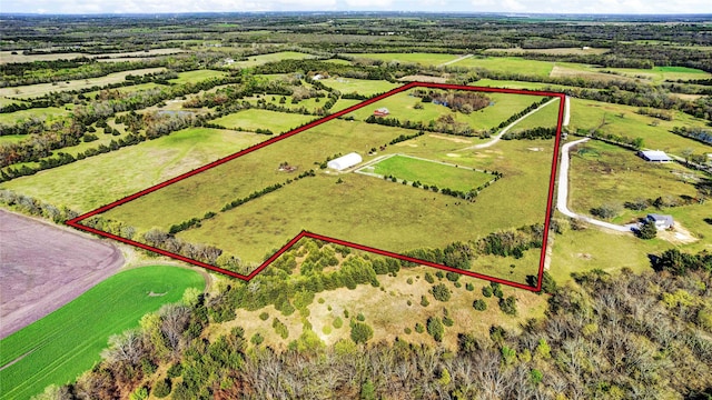 birds eye view of property with a rural view