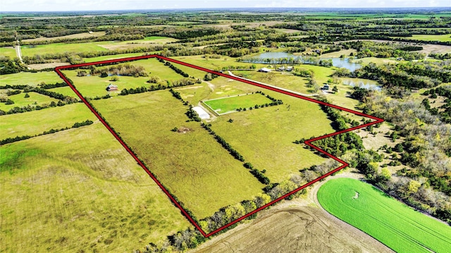 drone / aerial view with a water view and a rural view