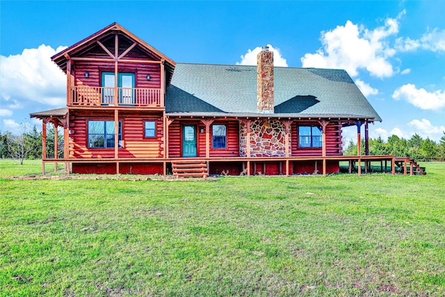 back of house featuring a lawn, log siding, roof with shingles, and a chimney