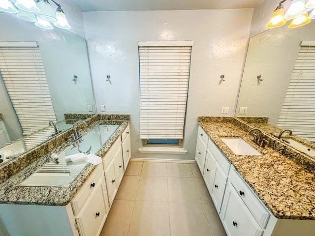 4424 Denver Dr, Plano, TX 75093 - full bathroom featuring tile patterned flooring, two vanities, a chandelier, and a sink