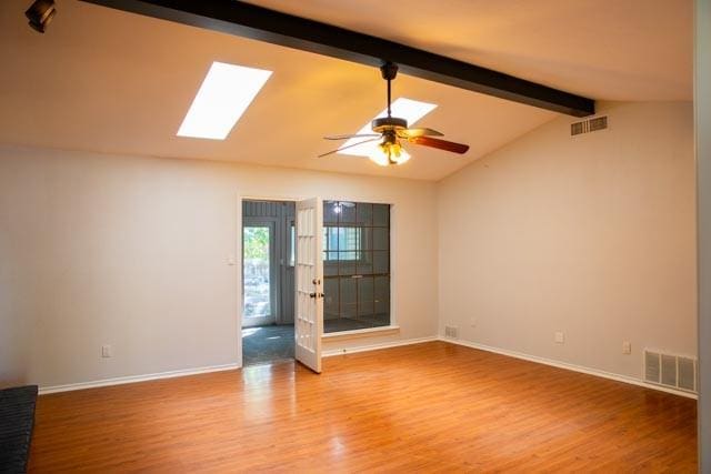 4424 Denver Dr, Plano, TX 75093 - spare room with lofted ceiling with skylight, visible vents, ceiling fan, and wood finished floors