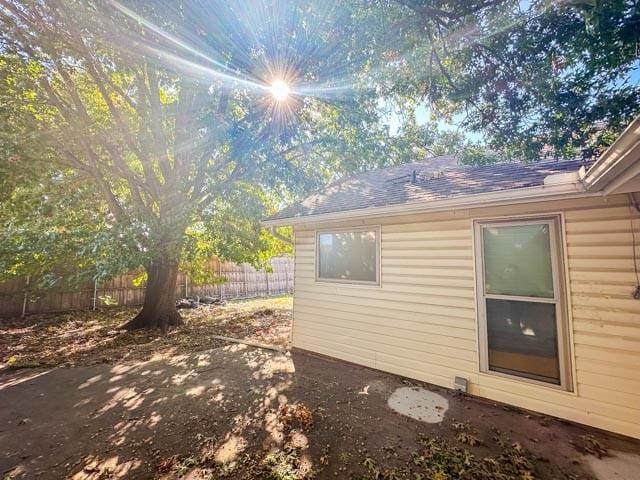 4424 Denver Dr, Plano, TX 75093 - view of side of home with fence and roof with shingles
