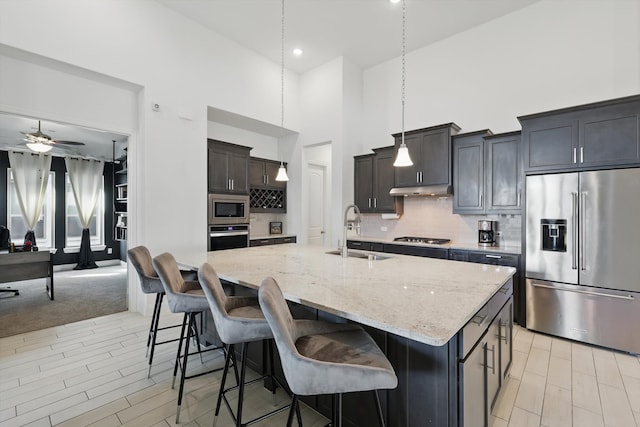 1820 Climbing Ct, Argyle, TX 76226 - kitchen featuring stainless steel appliances, a high ceiling, light stone countertops, tasteful backsplash, and ceiling fan
