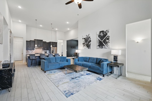1820 Climbing Ct, Argyle, TX 76226 - living area featuring ceiling fan, a towering ceiling, light wood-style flooring, and recessed lighting