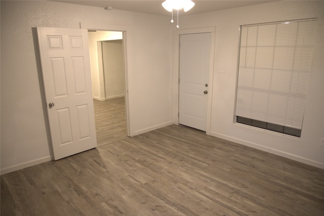 empty room featuring baseboards, ceiling fan, and wood finished floors