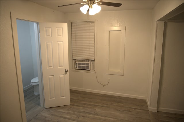 laundry area with wood finished floors, baseboards, ceiling fan, and cooling unit