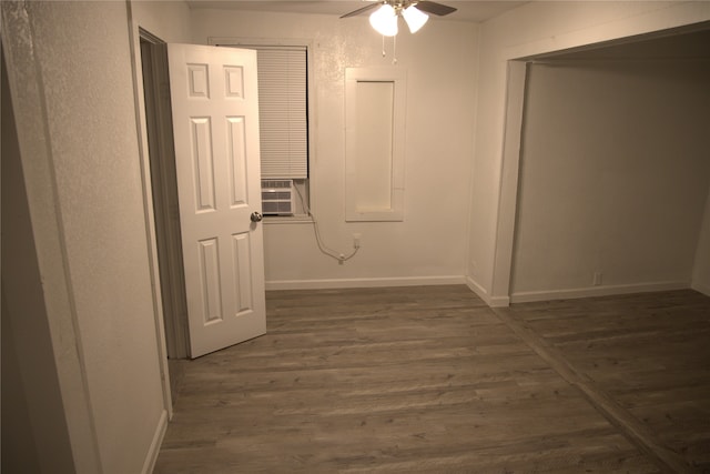hallway with baseboards, dark wood finished floors, and cooling unit