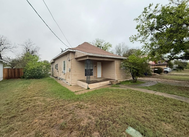 bungalow with a front lawn and fence