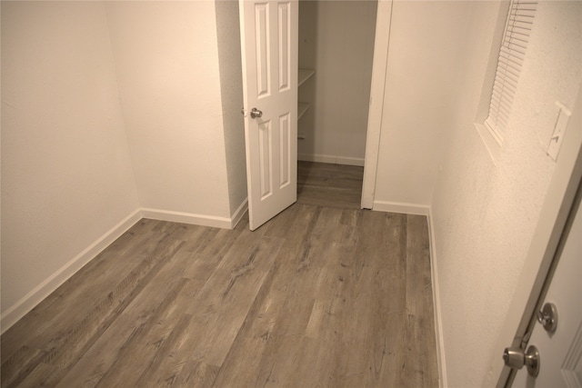 interior space featuring baseboards and wood finished floors