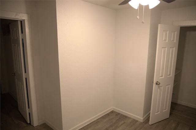 interior space with baseboards and wood finished floors