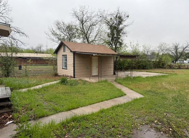 view of outbuilding featuring fence and an outdoor structure