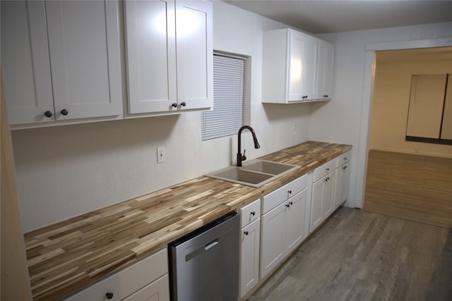 kitchen with wood counters, light wood-type flooring, a sink, and dishwasher