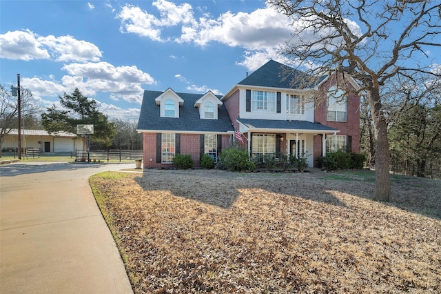 640 County Road 203, Collinsville, TX 76233 - view of front of property with concrete driveway, fence, brick siding, and roof with shingles