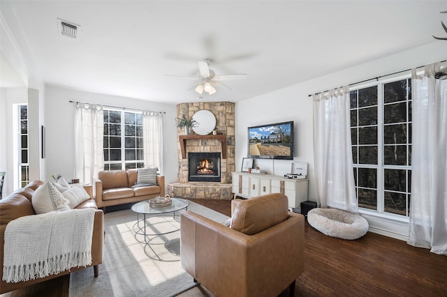 640 County Road 203, Collinsville, TX 76233 - living room featuring a ceiling fan, wood finished floors, a fireplace, and visible vents