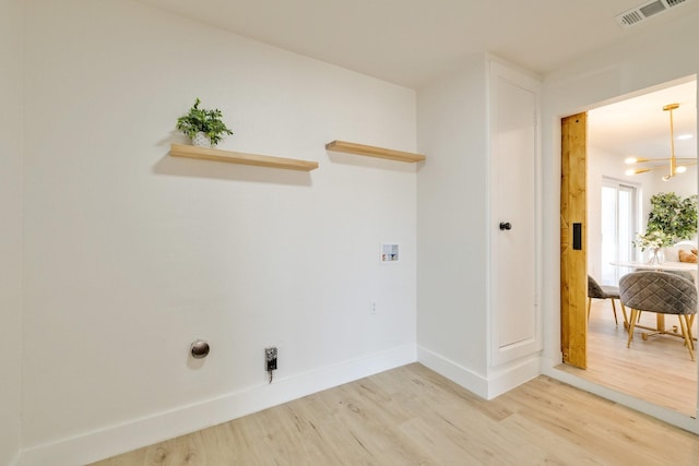 laundry area with hookup for a washing machine, baseboards, visible vents, laundry area, and light wood-style floors