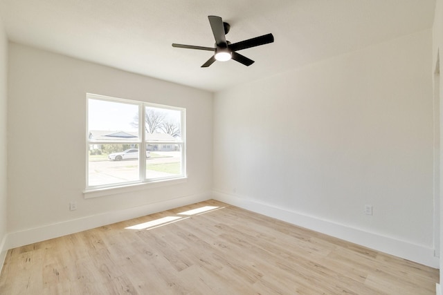 unfurnished room with baseboards, light wood-type flooring, and a ceiling fan
