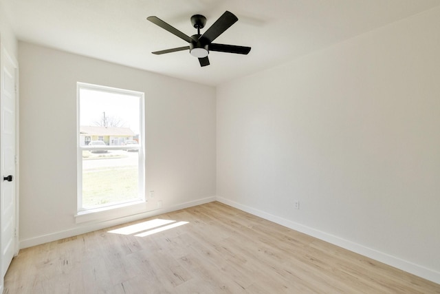 empty room with light wood-type flooring, baseboards, and a ceiling fan