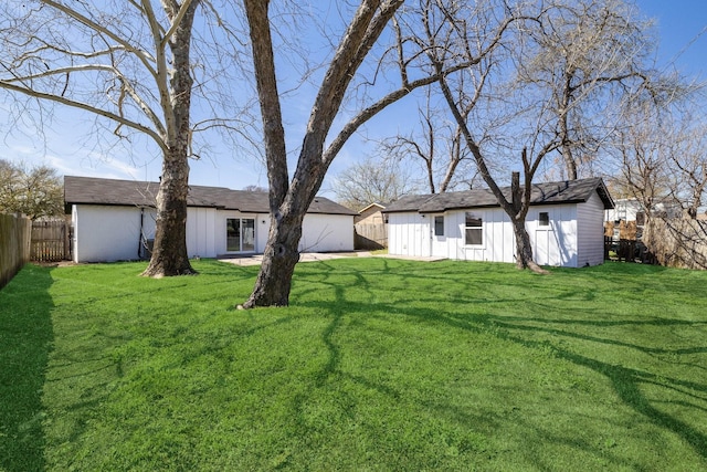view of yard featuring an outbuilding and a fenced backyard