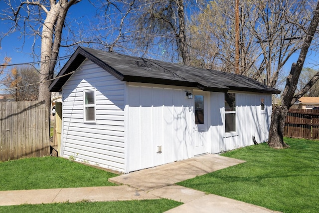 view of outbuilding featuring an outdoor structure and fence
