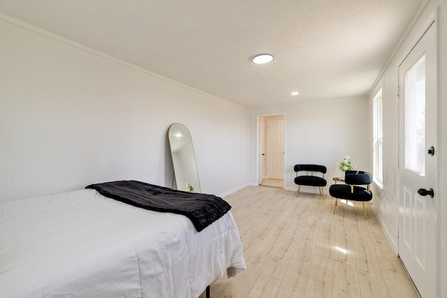 bedroom featuring light wood-style flooring and baseboards