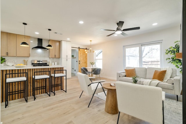 living room with visible vents, recessed lighting, light wood-type flooring, and ceiling fan