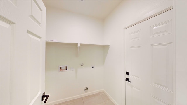 2227 Stoneman St, Dallas, TX 75215 - laundry room with hookup for a washing machine, hookup for a gas dryer, hookup for an electric dryer, light tile patterned floors, and baseboards
